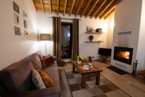 a living room with a couch and a fireplace at Sete Cidades Quinta Da Queiró in Sete Cidades