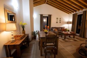 a living room with a table and a couch at Sete Cidades Quinta Da Queiró in Sete Cidades