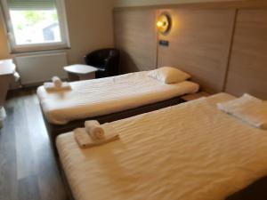 Postel nebo postele na pokoji v ubytování Hotell Stinsen