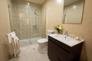 a bathroom with a toilet and a sink and a shower at Sete Cidades Quinta Da Queiró in Sete Cidades