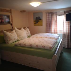 Ein Bett in einem Schlafzimmer mit durchschnittlicher statistischer Anzeige in der Unterkunft Ferienhof Plotzen in Hochkirch