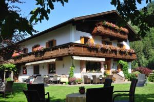 a large house with a lot of tables and chairs at Appartements Griesserhof in Oetz