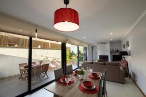 a dining room and living room with a table and chairs at Sete Cidades Quinta Da Queiró in Sete Cidades