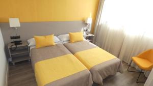 Postel nebo postele na pokoji v ubytování Hotel Zeus