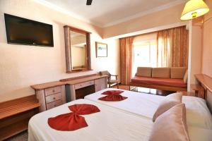 Łóżko lub łóżka w pokoju w obiekcie Hotel Manaus