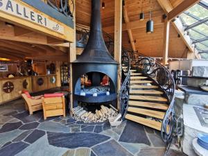 a spiral staircase in a room with a fireplace at Gudvangen Fjordtell in Gudvangen