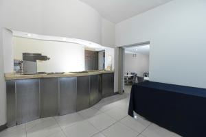 a kitchen with a counter in a room at Hotel Plaza del Arco - Monterrey in Monterrey
