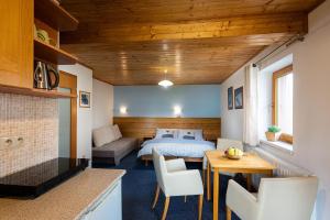 a bedroom with a bed and a table and chairs at Apartment Roháčik in Zuberec