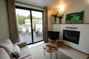a living room with a couch and a fireplace at Sete Cidades Quinta Da Queiró in Sete Cidades