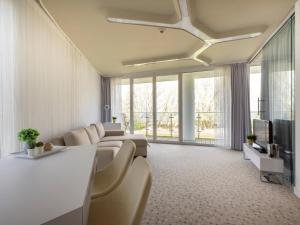 a living room with a couch and a tv at VacationClub – Ultra Marine Apartament 27 in Kołobrzeg