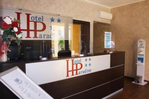 a hotel lobby with a hotel hbf sign on the wall at Hotel Paradiso in Falerna