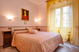 a bedroom with a bed and a window at B&B Locanda Il Tufo Rosa in Pitigliano