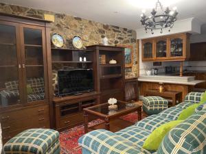 a living room with a couch and a table at Casita Piñeiro estilo rural in Boiro