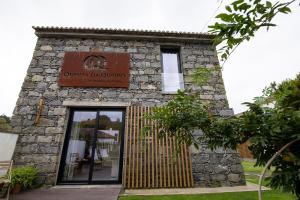 a building with a sign on the front of it at Sete Cidades Quinta Da Queiró in Sete Cidades