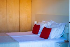 a bedroom with a bed and a dresser at INLIMA Hotel & Spa in Ponte de Lima