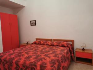 Postel nebo postele na pokoji v ubytování ANFORA Rosso