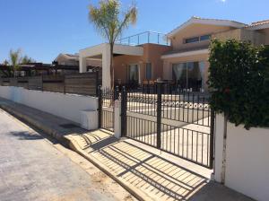 a gate in front of a house at Dream House Latchi Villa in Polis Chrysochous