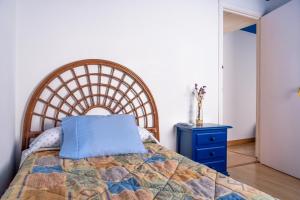 a bedroom with a bed with a blue pillow on it at Casa de Chocolate in Martos