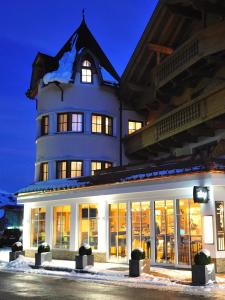 a large white building with snow on top of it at Hotel Garni Castel B&B in Ischgl