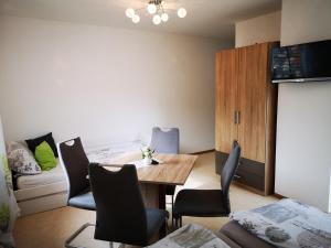 a room with a dining room table and chairs at Angeln am Regen - Angelhof Posl in Nittenau