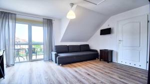 een woonkamer met een bank en een balkon bij Ow Alfa in Rewal