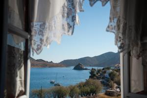 a view of a body of water from a window at Apolafsis Studios in Patmos