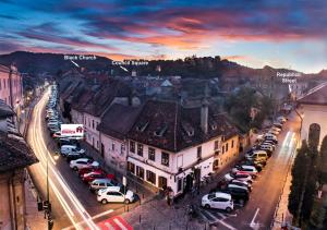 a city with cars parked in a parking lot at Apartment BIANCA in Braşov