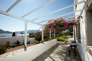 a balcony with pink flowers on a building at Apolafsis Studios in Patmos
