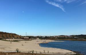 a beach with a group of people on it at Casas da Baronia in Vila Nova da Baronia