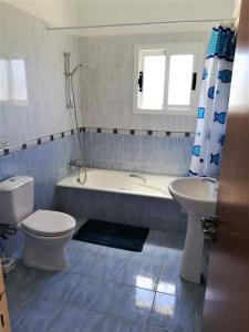 a bathroom with a tub and a toilet and a sink at Gabriella in Peyia