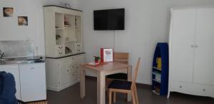 a kitchen with a table and a small table with a chair at "Klein & Fein" in Überlingen