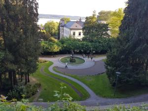 a view of a park with a building and trees at "Klein & Fein" in Überlingen