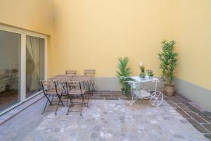 a patio with a table and chairs on a patio at Lovely Loft in Reggio Emilia in Reggio Emilia