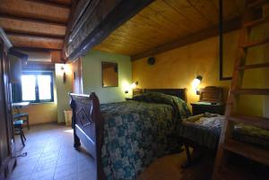 a bedroom with a bed and a wooden ceiling at B&B Edera in Castagnole Piemonte