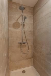 a shower with a shower head in a bathroom at Le studio de Laura in Castelnau-le-Lez