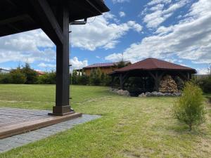 a pavilion with a gazebo in a yard at Sterburta in Rydzewo