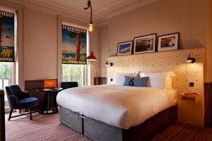 a bedroom with a large bed and two chairs at Bike & Boot Inns Scarborough - Leisure Hotels for Now in Scarborough