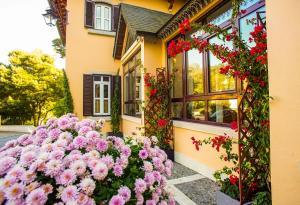 a bunch of flowers in front of a building at Sintra Marmoris Palace in Sintra