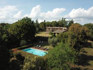 an aerial view of a house with a swimming pool at Borgo dei Fondi in Siena