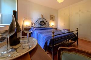a bedroom with a bed and a table with wine glasses at Panorami sul Trasimeno in San Feliciano