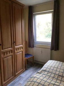 Schlafzimmer mit einem Bett und einem Fenster in der Unterkunft Ferienwohnung am Großen Plöner See in Ascheberg