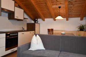 a living room with a couch and a kitchen at Haus Kargruber in Santa Maddalena