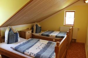 two beds in a room with a attic at Gästehaus zum Prinzenfelsen in Nagel