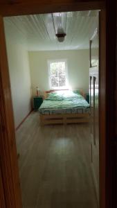 a bedroom with a bed in a room with a window at Zacisze in Kukle