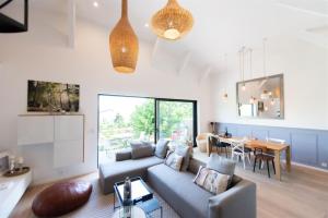 a living room with a couch and a table at LA Villa Du Lac in Annecy