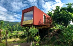 a tree house with a red roof on a hill at Welcome to Gerês-Green view in Vieira do Minho