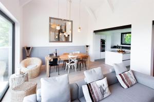 a living room with a couch and a table at LA Villa Du Lac in Annecy