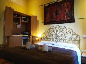 a bedroom with a large bed with a fancy headboard at B&B Venezia1964 - bedandbreakfastvenice it in Venice +59 photos