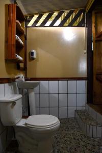 a bathroom with a toilet and a sink at Bella Vista Corcovado in Drake