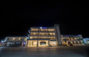 a large building at night with its lights on at Surfrider Resort Hotel in Saipan